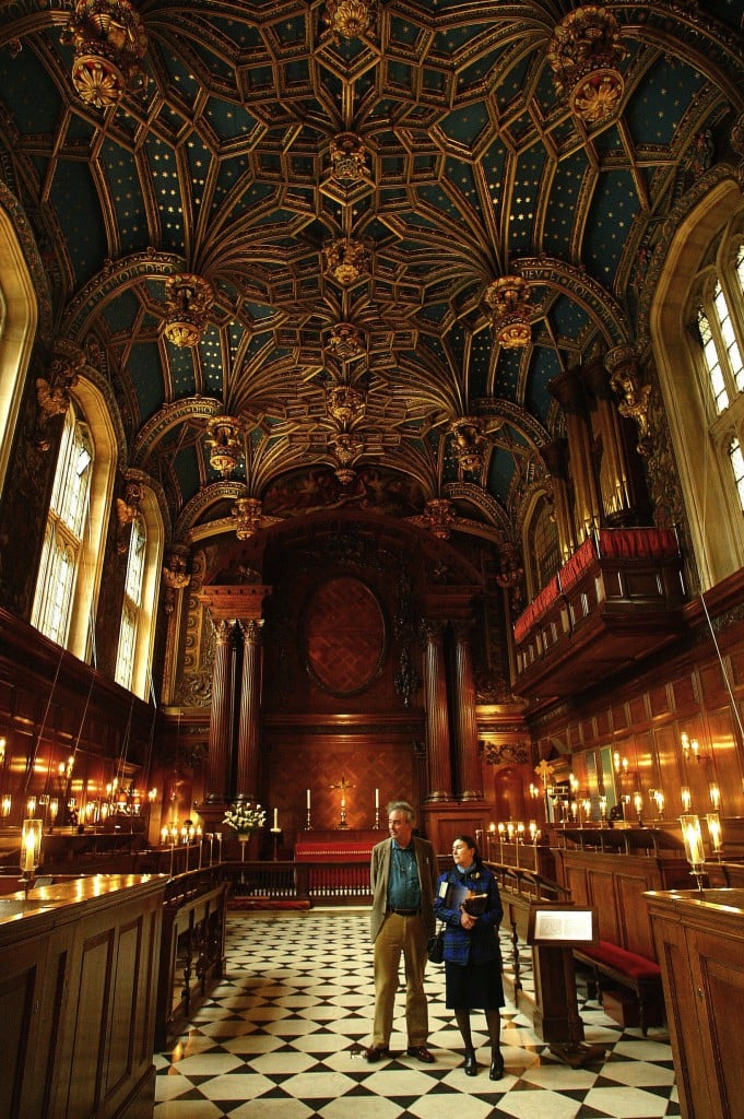 The ornate blue and gold vaulted ceiling of Hampton Court Palace Chapel Royal, featuring Tudor rose decorations and royal emblems